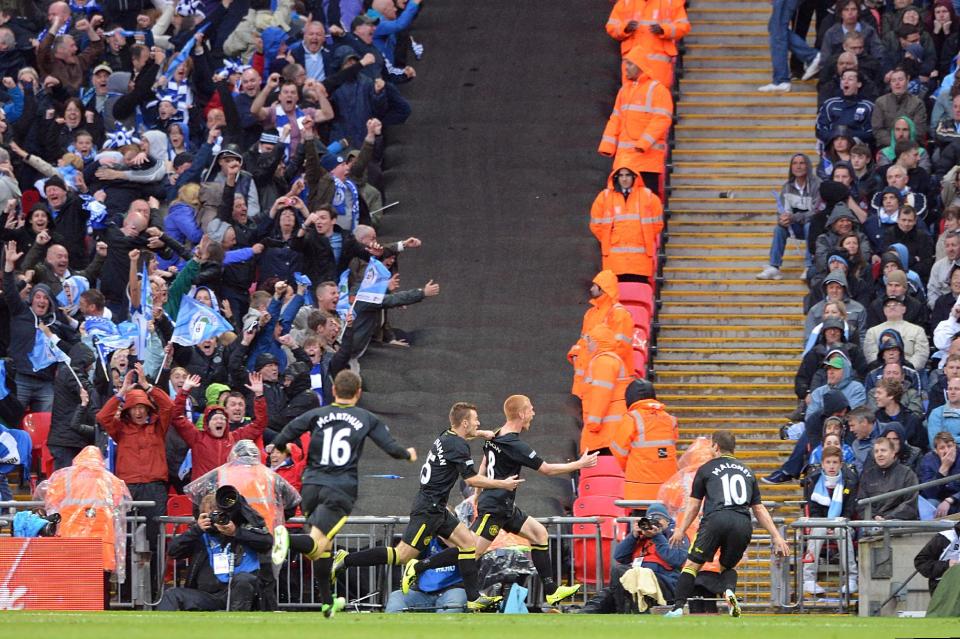 Wigan Athletic's Ben Watson (centre) celebrates scoring the winning goal