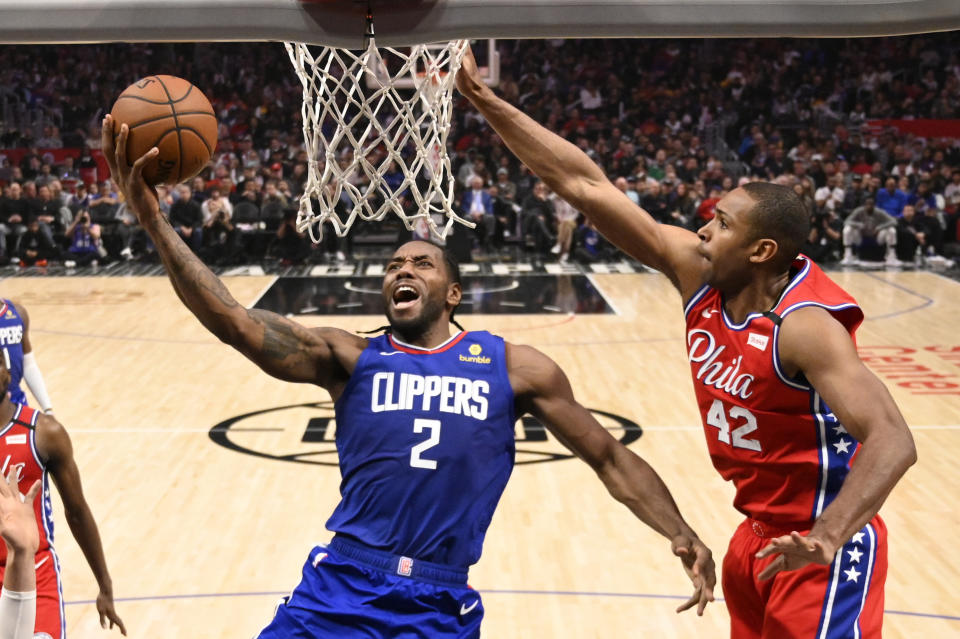 Los Angeles Clippers forward Kawhi Leonard, left, shoots as Philadelphia 76ers forward Al Horford defends during the second half of an NBA basketball game Sunday, March 1, 2020, in Los Angeles. The Clippers won 136-130. (AP Photo/Mark J. Terrill)