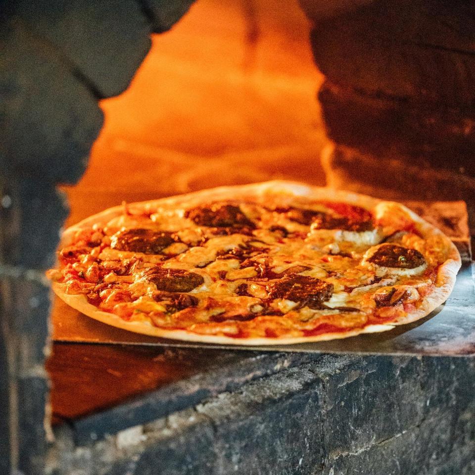 La Risata - Pizza being taken out from oven