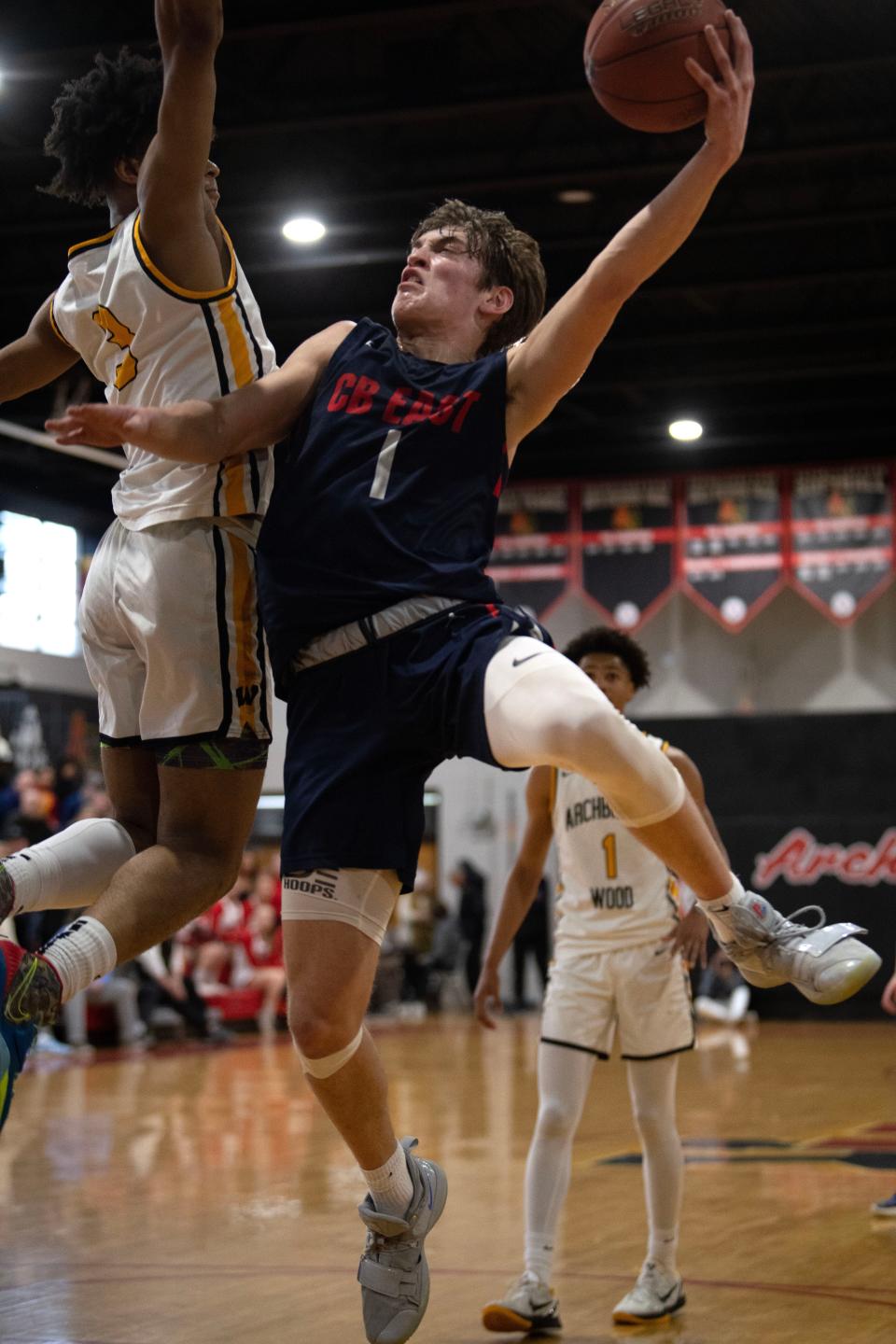 Central Bucks East's Jake Cummiskey goes up for a shot as Archbishop Wood's Milan Dean defends during a PIAA state playoff game in March.