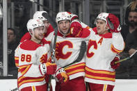 Calgary Flames left wing Milan Lucic, second from right, celebrates his goal with teammates left wing Andrew Mangiapane, left, defenseman Noah Hanifin, second from left, and center Mikael Backlund during the first period of an NHL hockey game against the Los Angeles Kings Thursday, Dec. 2, 2021, in Los Angeles. (AP Photo/Mark J. Terrill)