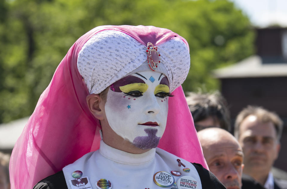 People attend a commemoration for prisoners assigned a pink triangle in the former Nazi concentration camp Buchenwald within the Christopher Street Day in Weimar, Germany, Sunday, June 23, 2019. There were 650 prisoners assigned a pink triangle in the Buchenwald concentration camp between 1937 and 1945. Many of them lost their lives. (AP Photo/Jens Meyer)