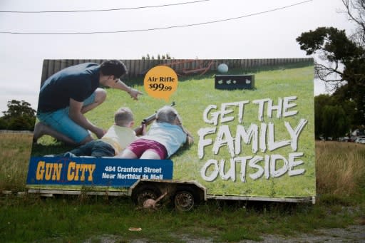 Anger has focussed on Gun City's billboard on a busy highway showing a man teaching two children how to shoot