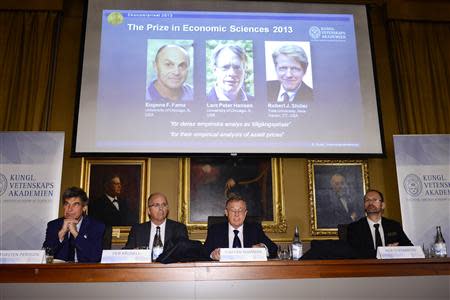 Members of the Royal Swedish Academy of Sciences Torsten Persson (L-R), Per Krusell, Staffan Normark and Per Stromberg announce the winners of the Nobel Prize in Economics, officially called the Sveriges Riksbank Prize in Economic Sciences in Memory of Alfred Nobel, during a news conference at the Royal Swedish Academy of Sciences in Stockholm October 14, 2013. REUTERS/Claudio Bresciani/TT News Agency