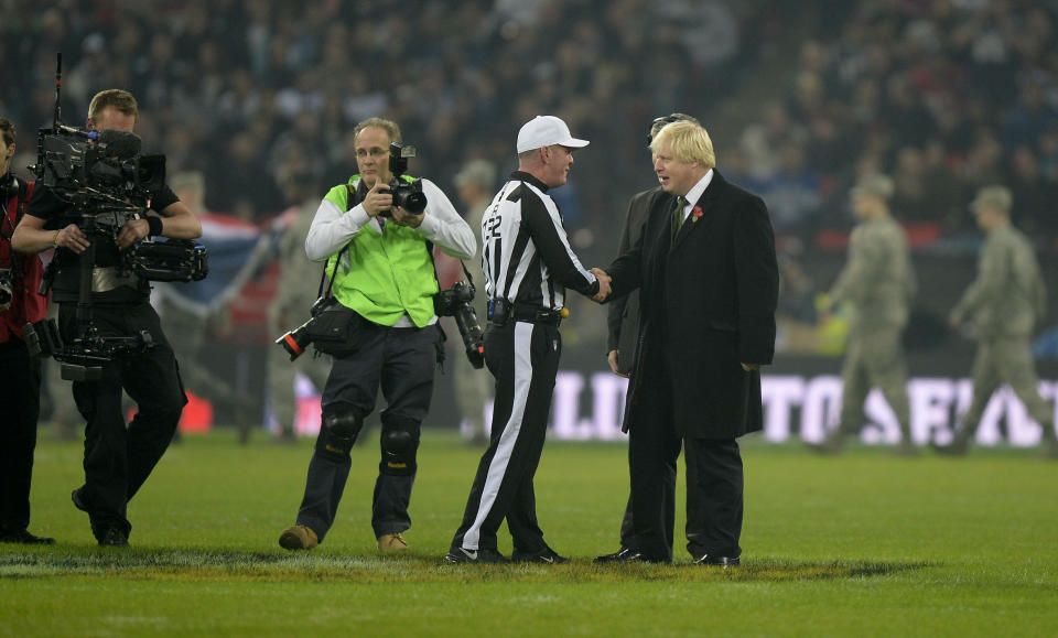 London Mayor Boris Johnson takes to the pitch before the NFL International match at Wembley Stadium, London. Picture date: Sunday November 9, 2014. See PA story GRIDIRON NFL. Photo credit should read: Andrew Matthews/PA Wire.