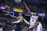 Indiana Pacers' Tyrese Haliburton (0) puts up a shot against Philadelphia 76ers' De'Anthony Melton (8) during the first half of an NBA basketball game, Monday, March 6, 2023, in Indianapolis. (AP Photo/Darron Cummings)