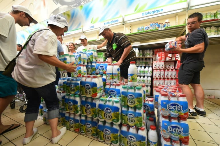 Dairy producers remove Lactalis dairy products from shelves at a supermarket in northwestern France, on August 25, 2016