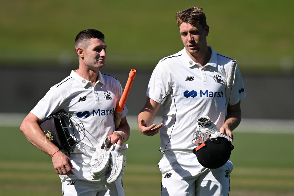 Cameron Bancroft and Cameron Green walk off the field.