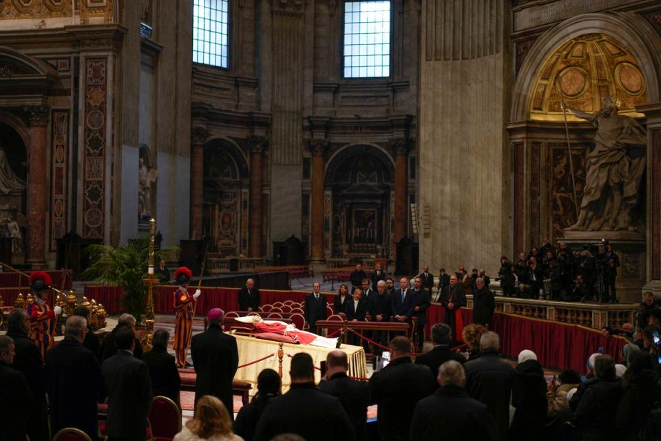 People look at the body of late Pope Emeritus Benedict XVI laid out in state inside St. Peter’s Basilica (AP)