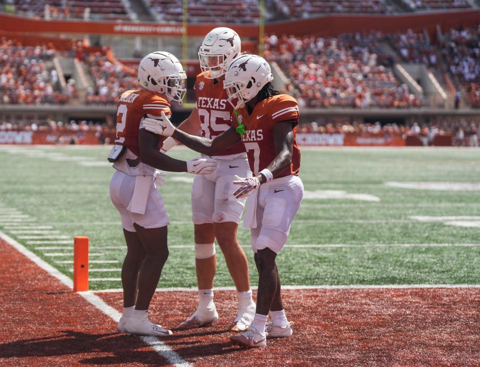 From left, Matthew Golden, Gunnar Helm and Isaiah Bond celebrate one of Golden's touchdown catches in the Longhorns' win Saturday.