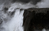 Huge waves break on the cliffs of the coast of Llanes, Spain, on Sunday. (Reuters)