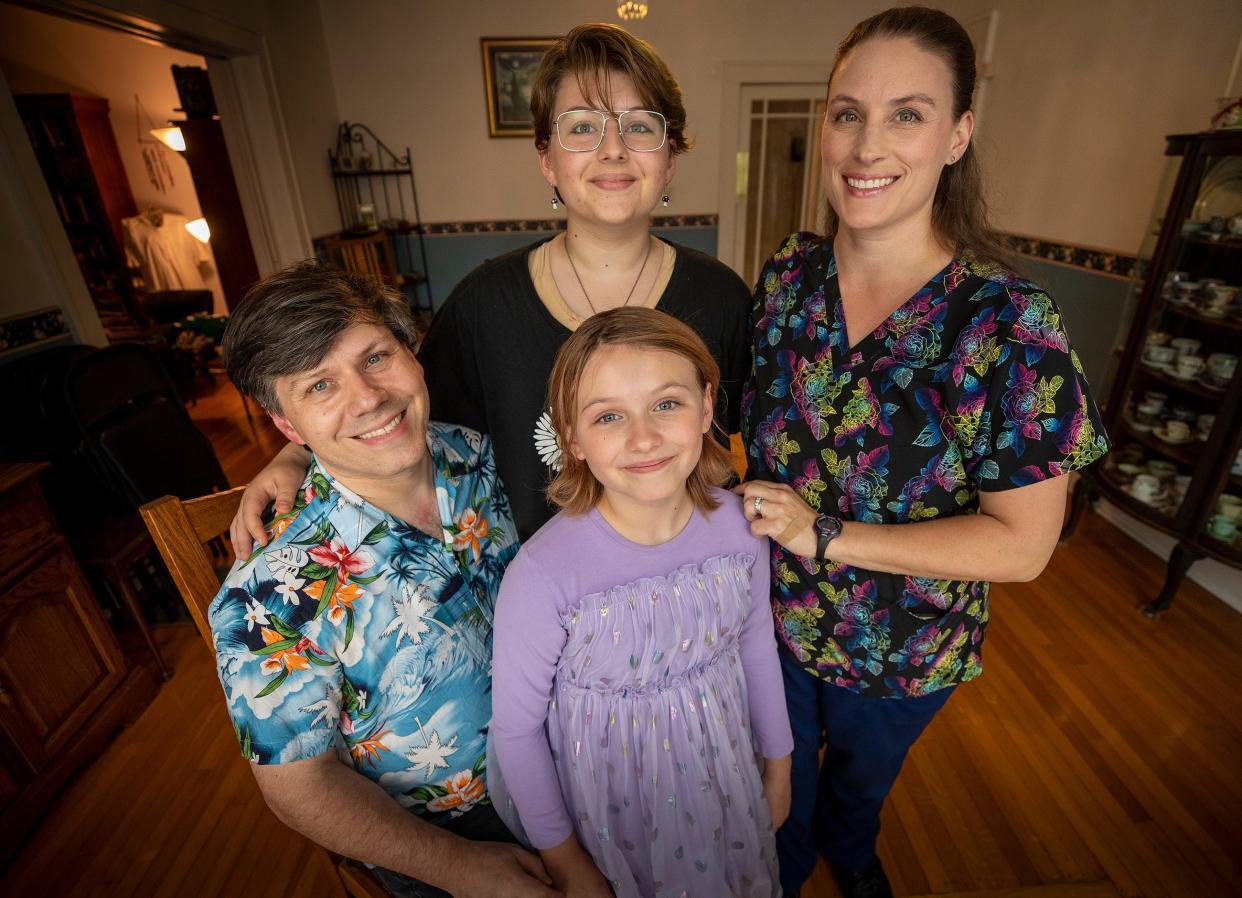 Alex Orasky, back center, is a 15-year-old in Lakeland who is gender fluid and considering a gender transition. Their parents are worried about the political climate in Florida and obstacles to gender-affirming care for children. Shown are Alex's father, Jeff Orasky, left, mother Vanessa Orasky and younger sister Vivien. Ernst Peters/The Ledger