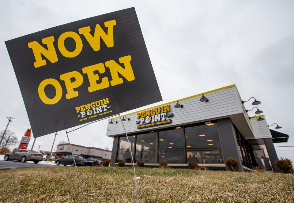 A sign reads “Now Open” outside Penguin Point’s new South Bend location on Monday, Jan. 17, 2022.