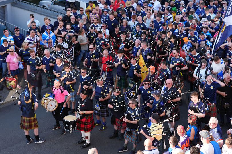 Bagpipers lead the march