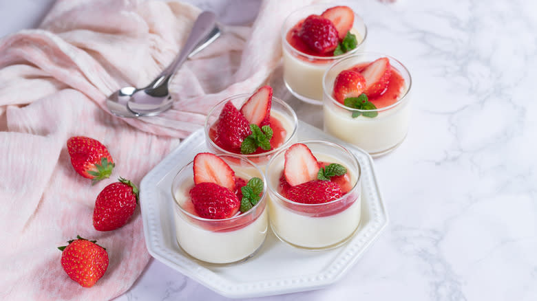 Small cups of panna cotta and strawberries