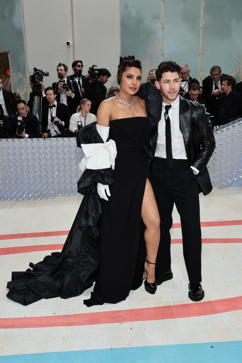 Priyanka Chopra Jonas and Nick Jonas being photographed on the red carpet at the 2023 Met Gala.