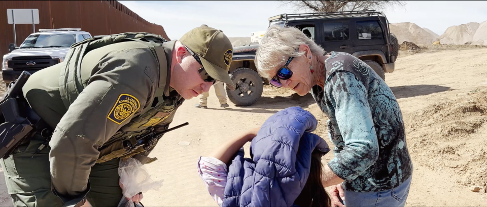 A U.S. Customs and Border Protection officer and Shura Wallin speak with a young child who crossed the U.S./Mexico border in the short film "Shura."