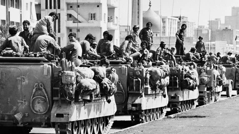 Israeli armored personnel carriers are positioned near a mosque on the outskirts of the Lebanese capital of Beirut on June 16, 1982. - Rina Castelnuovo/AP