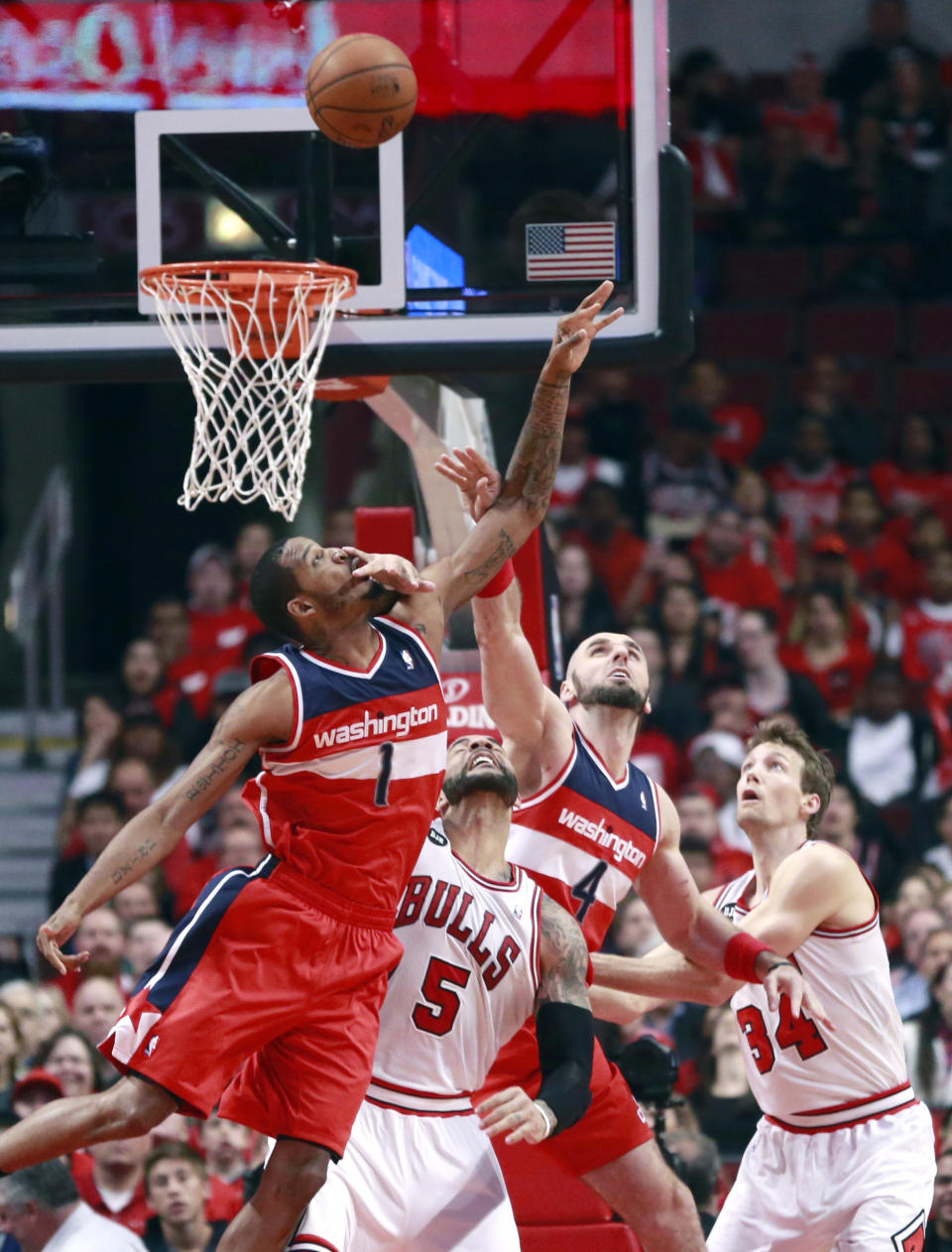 Washington Wizards forward Trevor Ariza (1), Chicago Bulls forward Carlos Boozer (5), Marcin Gortat (4) and Mike Dunleavy (34), battle for a rebound during the first half of Game 5 in an opening-round NBA basketball playoff series Tuesday, April 29, 2014, in Chicago. (AP Photo/Charles Rex Arbogast)