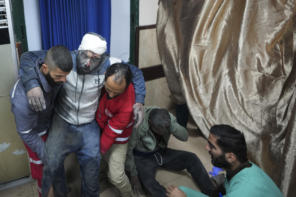 Palestinians wounded in the Israeli bombardment of the Gaza Strip are brought to the hospital in Deir al Balah, Gaza Strip, on Tuesday, Dec. 19, 2023. (AP Photo/Adel Hana)