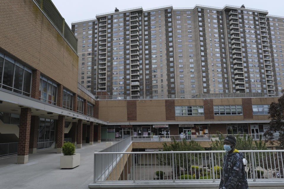 People walk through a shopping and community center inside of Co-op City in the Bronx borough of New York, Wednesday, May 6, 2020. Within the Bronx, almost no place has been hit as hard as Co-op City. Data released by city health officials Monday revealed that the virus has killed at least 155 people living in the zip code that covers the complex. That’s roughly 1 of every 282 residents. (AP Photo/Seth Wenig)