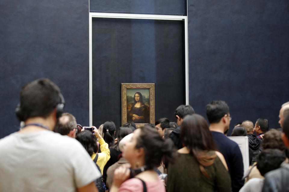 Visitors queue to see the painting Mona Lisa (La Joconde) by Leonardo Da Vinci as it returns in the gallery where it is normally displayed, after works on the color of the walls and a new glass screen, at the Louvre museum in Paris, France, October 7, 2019.  REUTERS/Philippe Wojazer