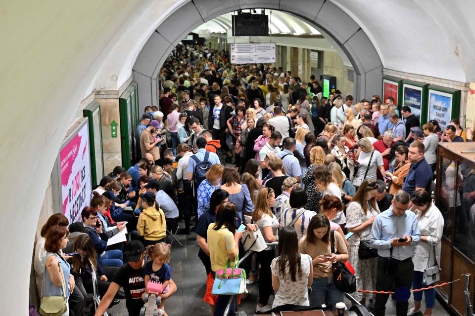Local residents take shelter in a metro station in the center of Kyiv during a Russian missile strike on May 29, 2023. Russia fired a barrage of missiles at Kyiv on Monday sending panicked residents running for shelter in an unusual daytime attack on the Ukrainian capital following overnight strikes. (Photo by Sergei SUPINSKY / AFP) (Photo by SERGEI SUPINSKY/AFP via Getty Images) ORIG FILE ID: AFP_33GH78J.jpg