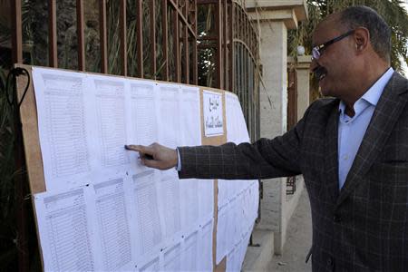 A man looks for his name at a polling station in Benghazi February 20, 2014. REUTERS/Esam Omran Al-Fetori