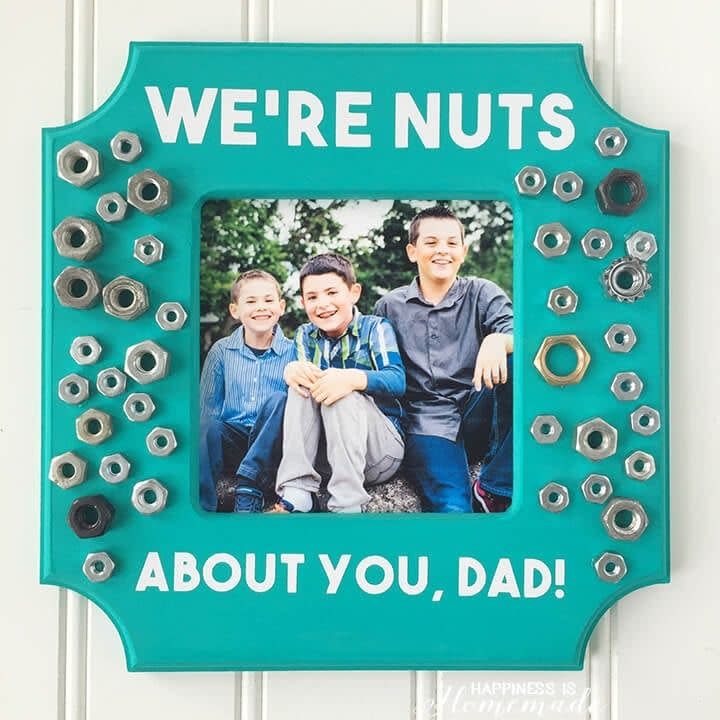 a frame with metal nuts of various sizes glued to it the frame has a message that says we're nuts about you dad