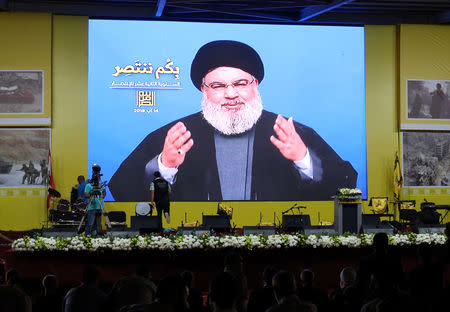 Lebanon's Hezbollah leader Sayyed Hassan Nasrallah gestures as he addresses his supporters via a screen in Beirut, Lebanon August 14, 2018. REUTERS/Aziz Taher