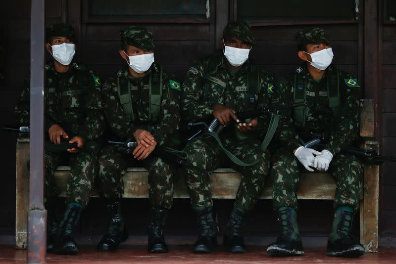 Brazilian army soldiers wearing protective face masks are seen at the 4th Surucucu Frontier Platoon of the Brazilian army in the municipality of Alto Alegre, state of Roraima