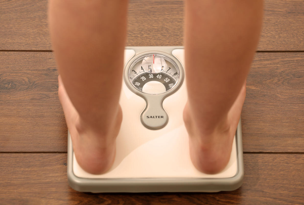 Embargoed to 0001 Monday July 27 Picture posed by model File photo dated 03/03/14 of an 11 year old girl using a set of weighing scales. Prime Minister Boris Johnson will announce the end of confectionery displays at store checkouts and ban junk food adverts on TV before 9pm as he looks to encourage Britons to shed the pounds.