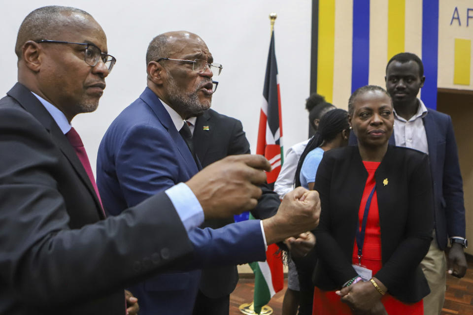 Haiti's Prime Minister Ariel Henry, second left, after giving a public lecture at the United States International University (USIU) in Nairobi, Kenya, Friday March. 1, 2024. Haitian Prime Minister Ariel Henry said Friday elections in his country need to be held as soon as possible in order to bring stability to the troubled Caribbean nation facing gang violence that threatens to overran government. Henry is in Kenya trying to salvage the deployment of a foreign armed force to Haiti to help combat gangs. (AP Photo/Andrew Kasuku)