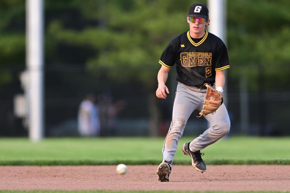 Garfield's Brandyn Bogucki fields a ball during the second inning against Kirtland in an OHSAA district semifinal Monday night at Cene Park in Struthers.