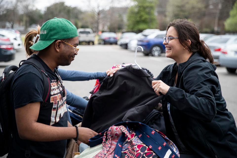 D’Angelo Anderson, a first-generation student, smiles as Jacki Rodriguez, director of the office of first-generation student success, holds up a suit jacket for him to look at that had been donated for the career closet donation drive at the University of Memphis on Friday, March 8, 2024. The donation drive serves to give first-generation students access to professional clothing.