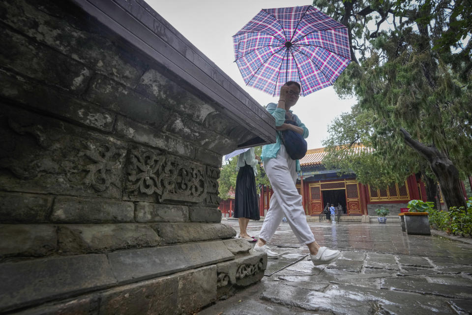 Visitors tour the Garden of the Palace of Compassion and Tranquility, known as Dining gong huayuan, at the Forbidden City in Beijing on Thursday, July 13, 2023. (AP Photo/Andy Wong)