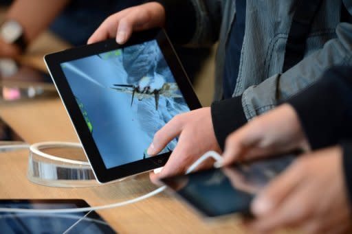 A man is seen playing a game on an iPad. Just weeks after its momentous launch of the iPhone 5, Apple is back with what is expected to be another hot gadget -- a 'mini' version of its market-leading iPad tablet