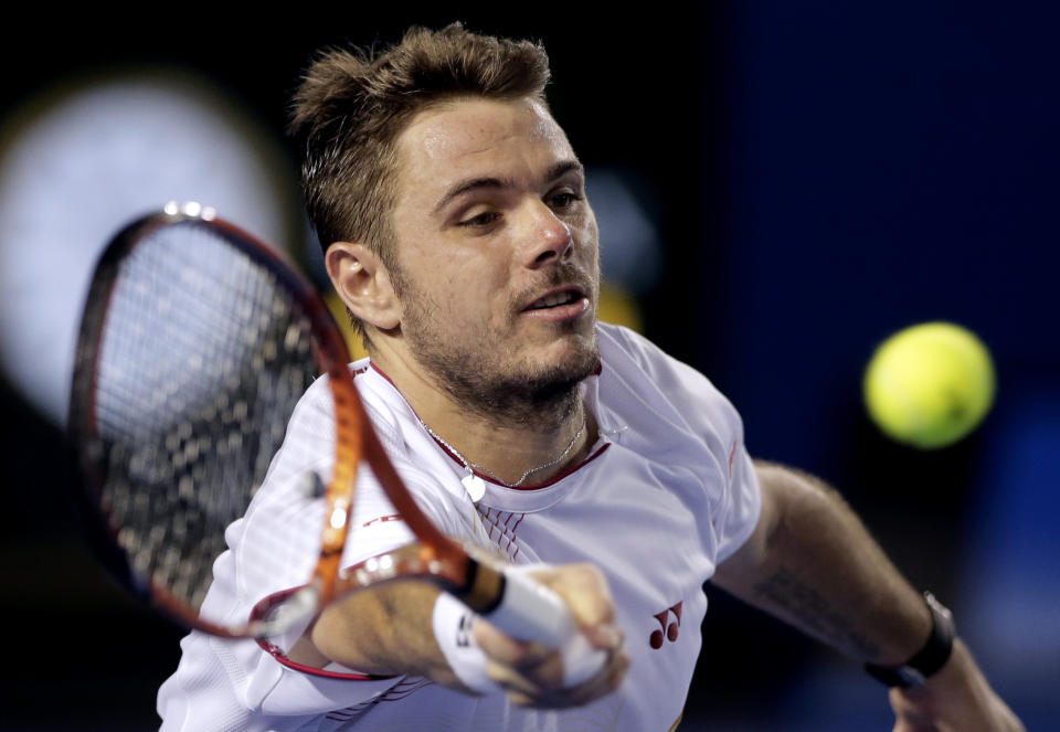 Stanislas Wawrinka of Switzerland makes a forehand return to Tomas Berdych of the Czech Republic during their semifinal at the Australian Open tennis championship in Melbourne, Australia, Thursday, Jan. 23, 2014.(AP Photo/Rick Rycroft)