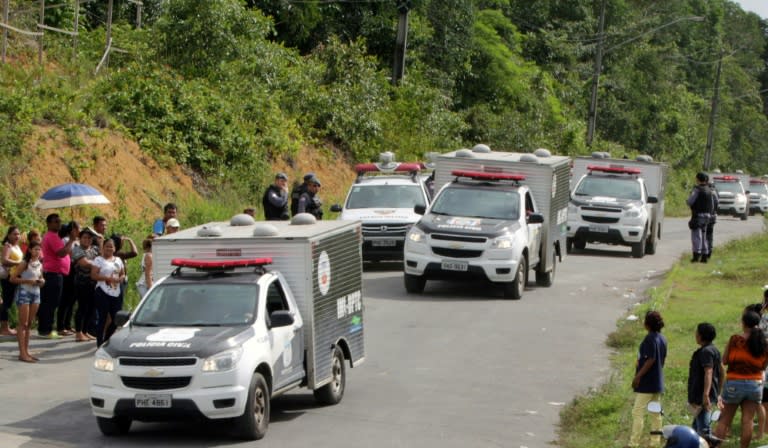 Vans of the Legal Medicine Institute carrying bodies of inmates killed during a riot, leave the Anisio Jobim Penitentiary Complex (Compaj) in Manaus, Brazil, on January 2, 2017 At least 60 people were killed in a prison riot in Brazil's Amazon region when fighting broke out between rival gangs