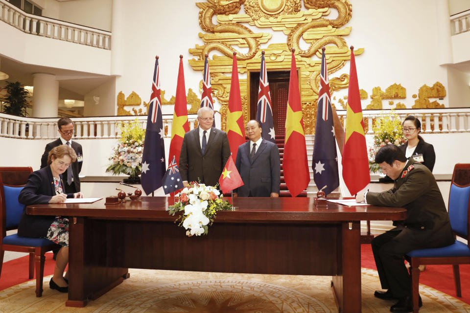 Australian Prime Minister Scott Morrison, center left, and his Vietnamese counterpart Nguyen Xuan Phuc, center right, attend a signing ceremony at the Government Office in Hanoi, Vietnam, Friday, Aug. 23, 2019. (AP Photo/Duc Thanh)