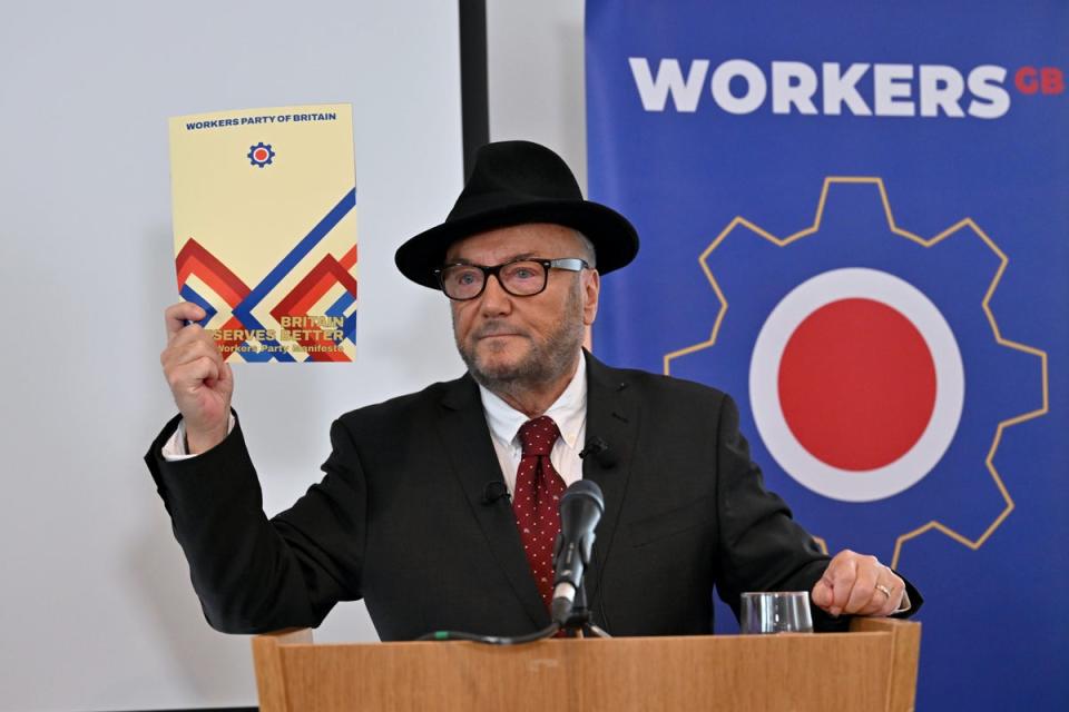 Leader of the Workers Party of Britain George Galloway holds a copy of the manifesto during his party’s manifesto launch on Wednesday (Getty Images)