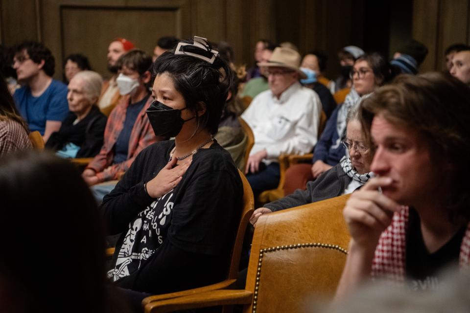 Catrina Macaraig holds a hand over her heart while listening to public comment calling for a cease fire in Gaza at the Asheville City Council meeting, March 12, 2024. “I’m here to support human lives,” Macaraig said, “Jewish, Palestinian, whoever has a beating heart.”