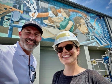 Jim Dodson and Megan Lingerfelt pose in front of the most recent mural on the ORNL Federal Credit Union-owned building at Broadway Avenue in Oak Ridge