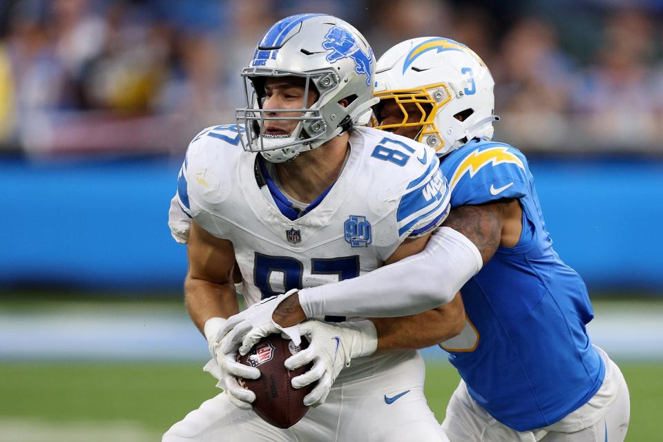 Sam LaPorta of the Detroit Lions runs with the ball against Derwin James Jr. of the Los Angeles Chargers during the fourth quarter at SoFi Stadium on November 12, 2023 in Inglewood, California.