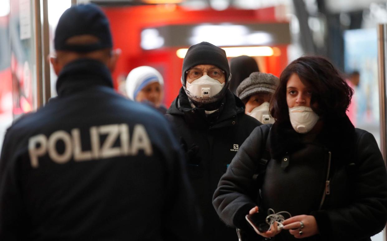 Police officers and soldiers check passengers leaving from Milan main train station, Italy, - Antonio Calanni /AP