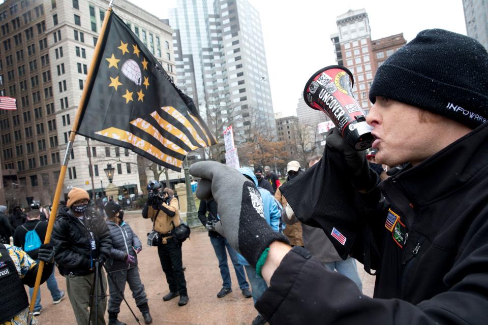 A man uses a bullhorn outside the Ohio Statehouse in Columbus on Jan. 17 while protesting the death of Ashli Babbitt, 35, who was shot to death at the riot at the U.S. Capitol Jan. 6.