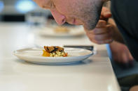 Dave Pirazzini smells cultivate chicken before sampling it at GOOD Meat's Alameda, Calif., headquarters on Thursday, Sept. 28, 2023. The company's cultivated chicken, which is grown from animal cells, is approved for sale in the United States and Singapore. (AP Photo/Noah Berger)