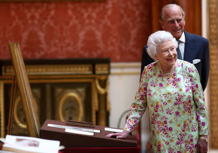 FILE PHOTO: Britain's Queen Elizabeth II and Prince Philip, Duke of Edinburgh stand next to a display of Spanish items from the Royal Collection at Buckingham Palace, London, Britain July 12, 2017. REUTERS/Neil Hall/File Photo