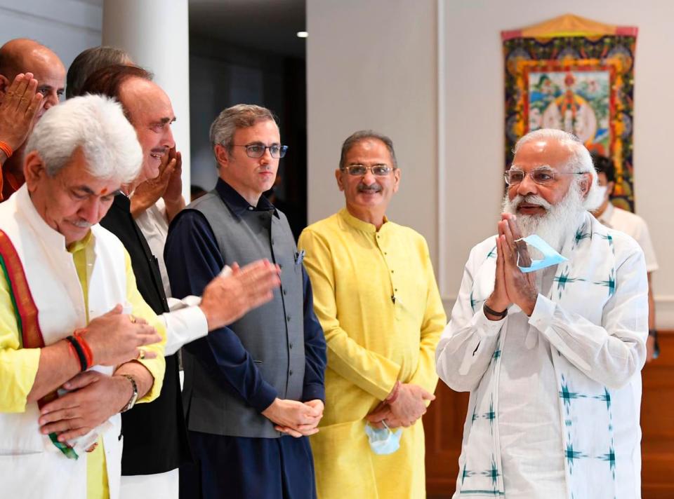 The photograph provided by the Prime Minister’s Office shows Indian PM Narendra Modi greeting members of various political parties before their meeting in New Delhi on 24 June, 2021 (AP)