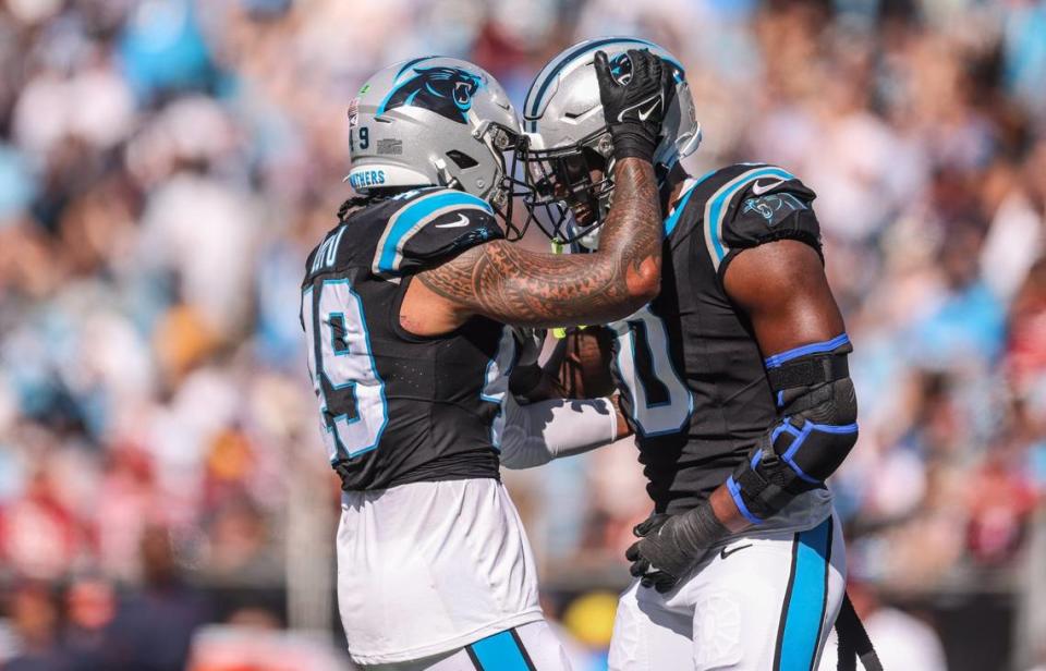 Carolina Panthers linebacker Brian Burns, right, and Carolina Panthers linebacker Frankie Luvu celebrate a sack against the Houston Texans at the Bank of America Stadium in Charlotte, N.C., on Sunday, October 29, 2023.